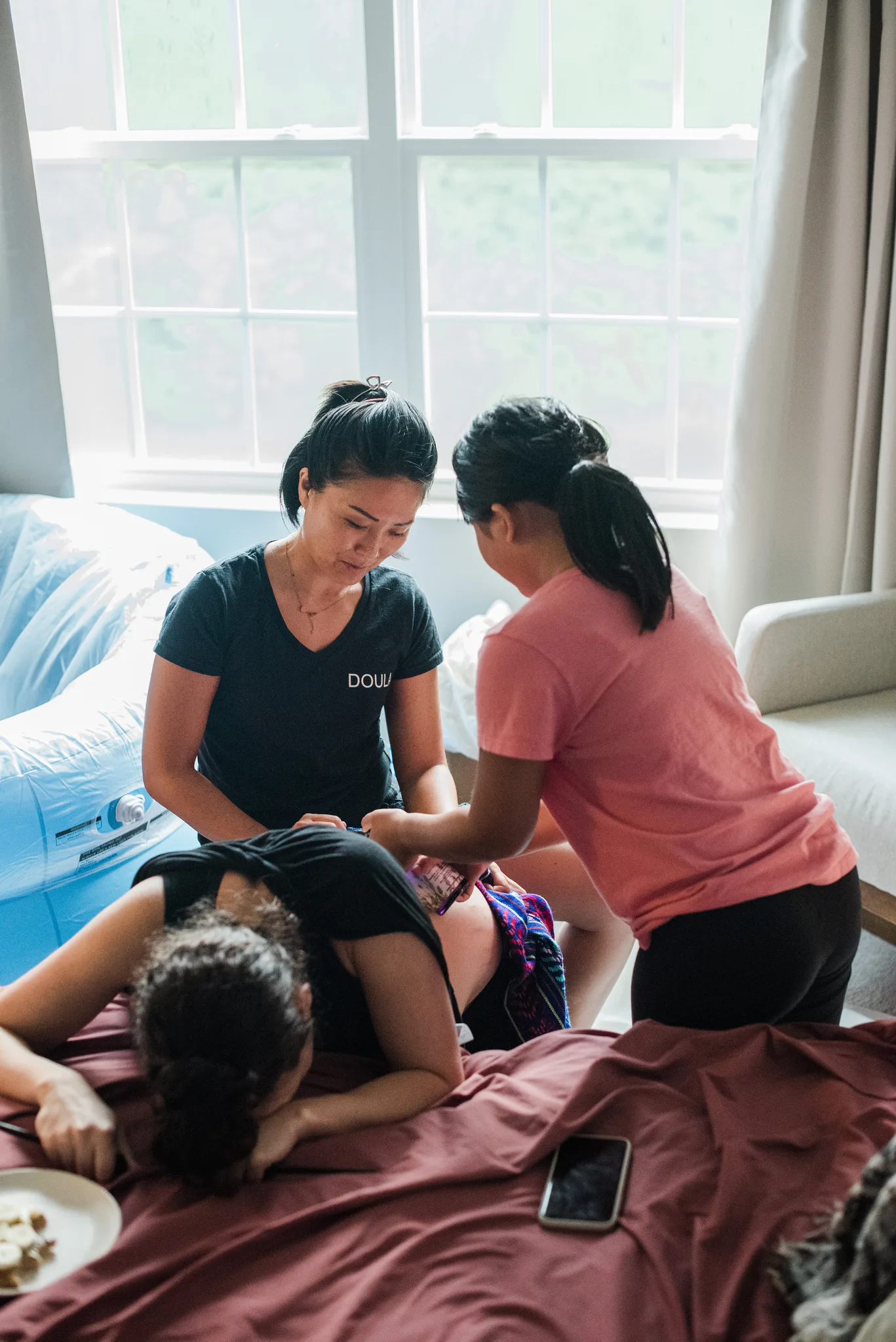 Irene supporting a mother during a water birth at home